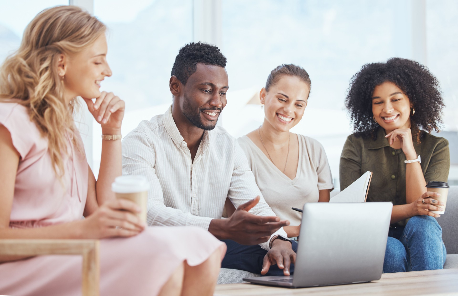 Business people, laptop planning and working in modern office for collaboration, team meeting and creative strategy. Diversity group employees watching online marketing campaign in advertising agency